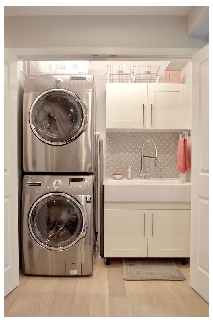 a washer and dryer sitting in a kitchen next to each other on top of a hard wood floor