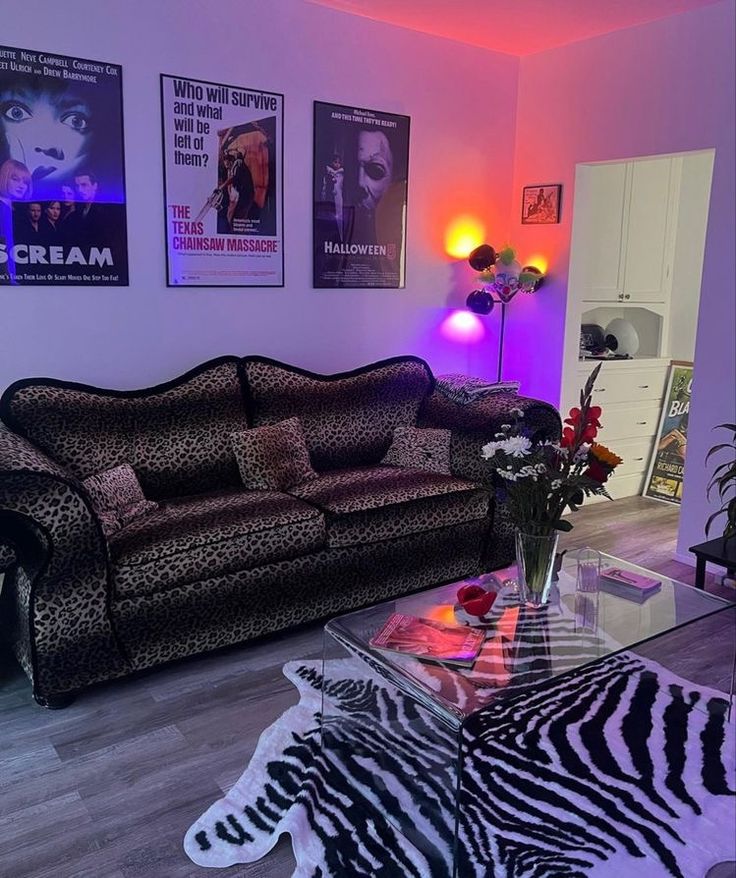 a living room with zebra print furniture and posters on the wall