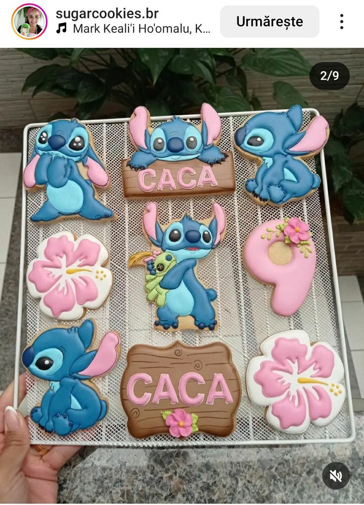 someone is holding up some decorated cookies