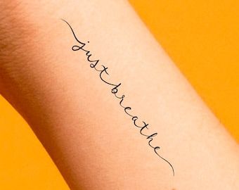 a woman's arm with the word love written in cursive writing on it