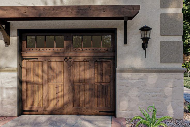 the front entrance to a house with two wooden doors