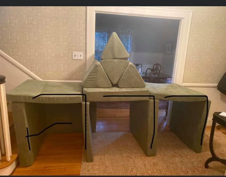 an origami table is shown in the middle of a living room with stairs leading up to it