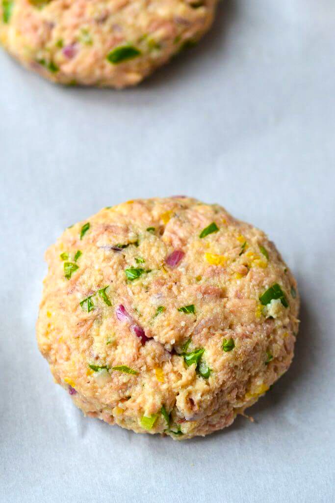 three cookies with different toppings sitting on top of a table