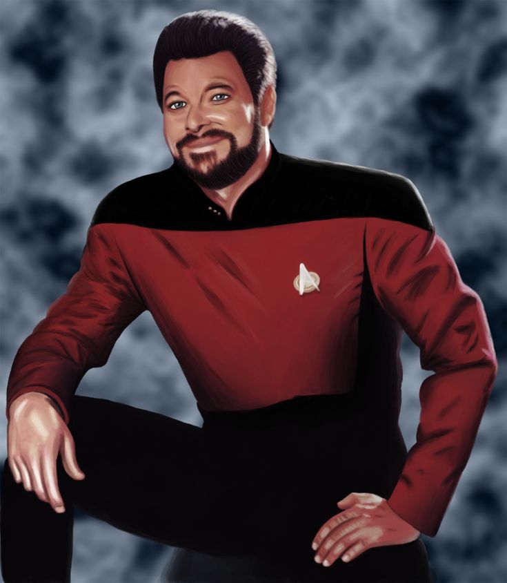 a man in a star trek uniform poses for a photo