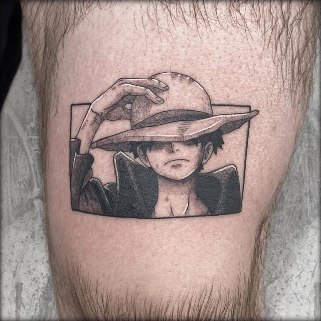 a man with a hat on his head is shown in black and white tattoo art