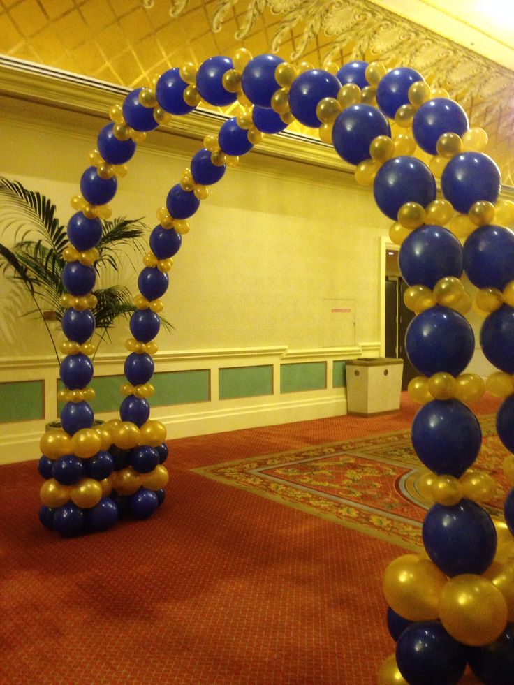 an arch made out of balloons in the middle of a room