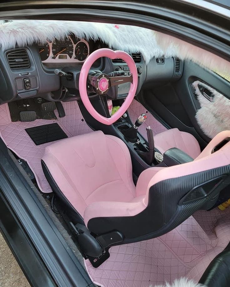 the interior of a car with pink and black trim