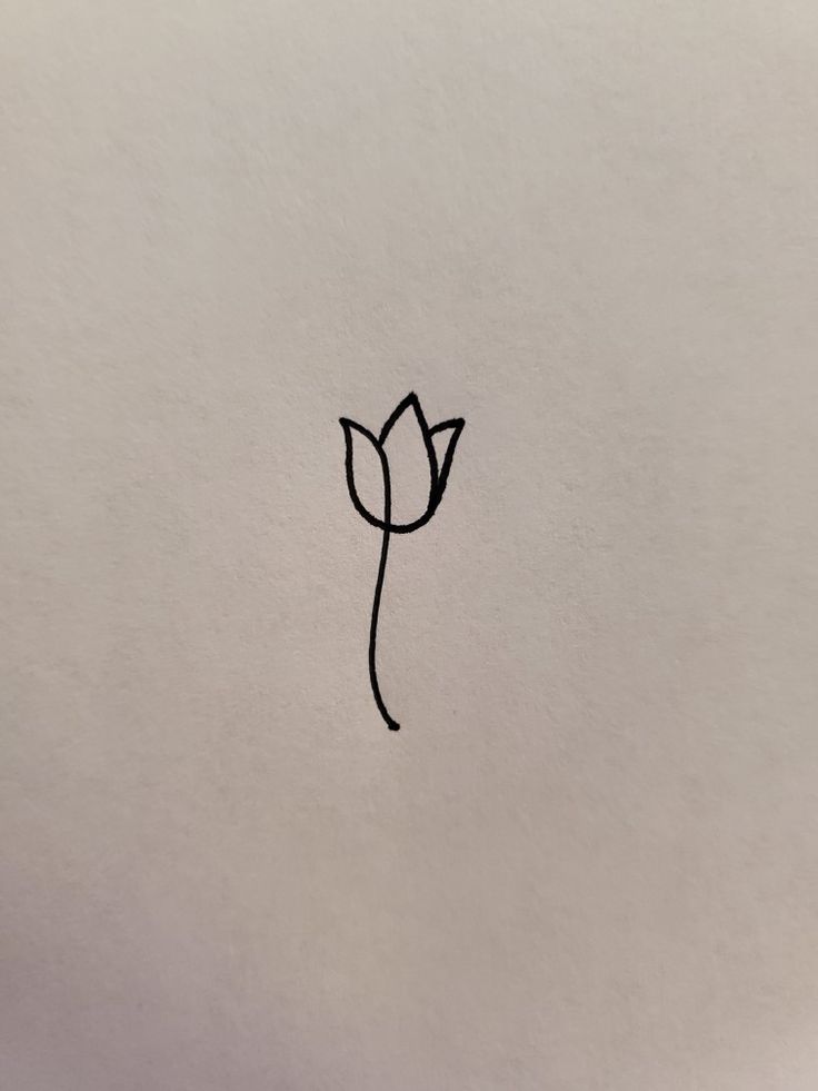 a black and white photo of a flower on a piece of paper with the word love written in it