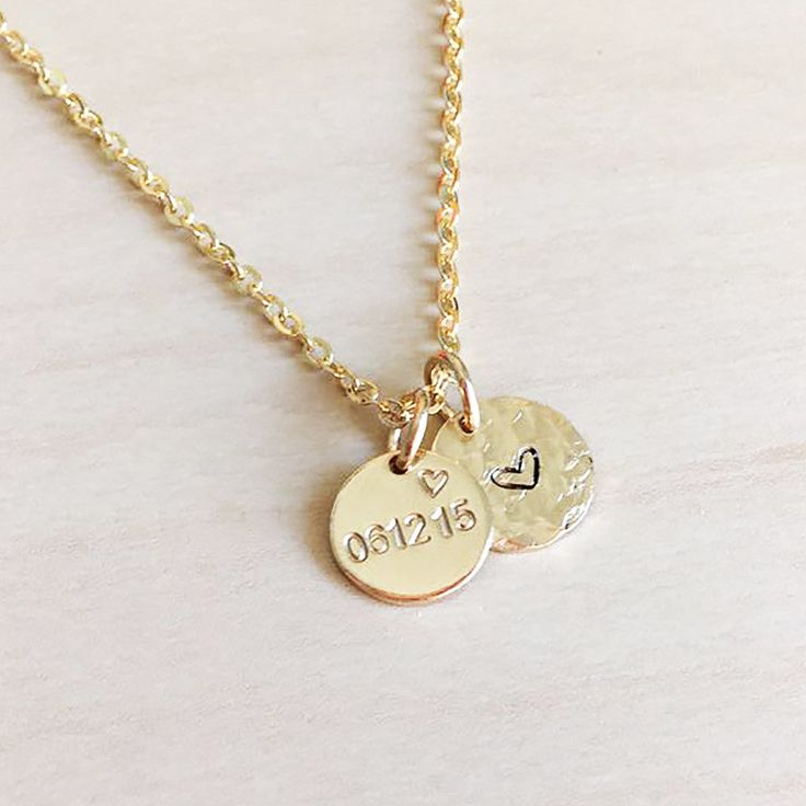 This beautiful dainty necklace features 2 of our Mini discs, 1 to contain a date, initial or (short) name/word of your choice, and the other is a disc with a love heart symbol. Mini Disc measures 9mm. 16", 18", 20" lengths with spring ring clasp. 14k Gold filled, 14k Rose gold filled or Sterling Silver. Available only in 1.5mm Tiny Block font. Handcrafted in Australia. Each piece is hand stamped & there may be slight variations such as with the letter alignment or spacing - this is not a defect Round Charm Necklaces For Wedding, Dainty Adjustable Charm Necklace With Heart Charm, Personalized Heart Pendant Charm Necklace For Everyday, Dainty Hand Stamped Round Disc Necklaces, Dainty Stamped Charm Necklaces For Everyday, Dainty Hand Stamped Round Disc Necklace, Personalized Dainty Heart Pendant Charm Necklace, Everyday Mother's Day Charm Necklace With Round Disc, Dainty Personalized Heart Pendant Charm Necklace