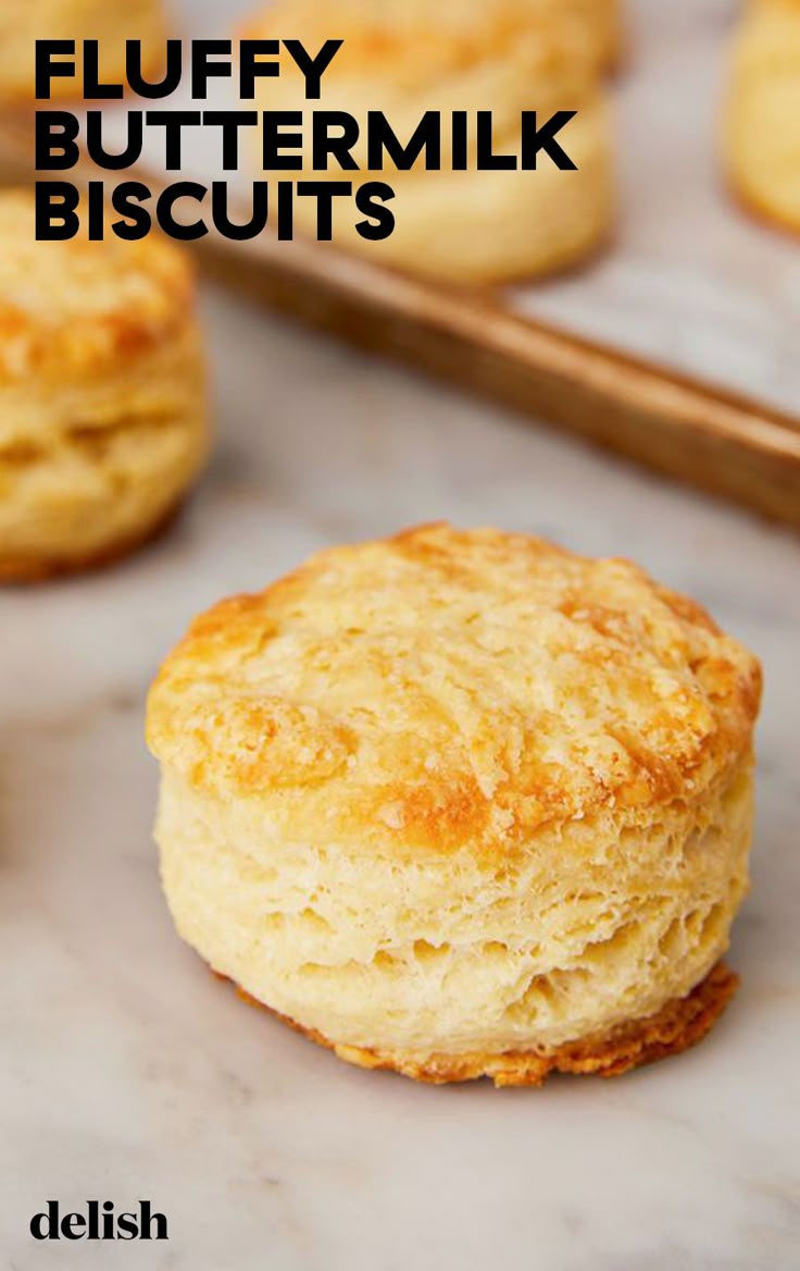 buttermilk biscuits on a baking sheet with text overlay that reads fluffy buttermilk biscuits