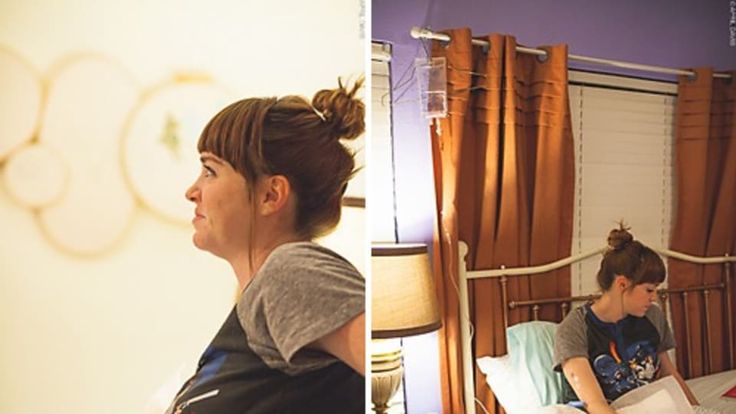 a woman sitting on top of a bed in a bedroom next to another woman laying down