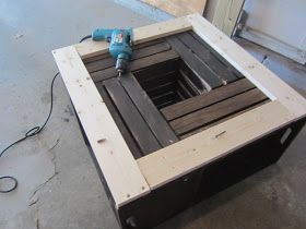 a table made out of pallets with a driller on top