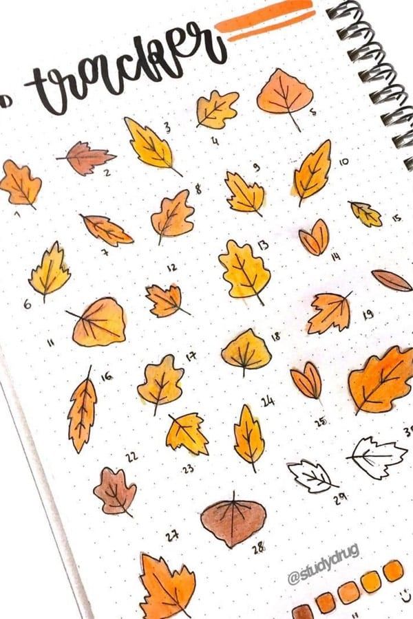 an open planner with autumn leaves on it