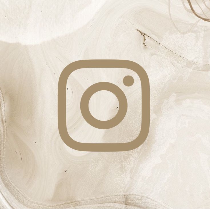 an instagram logo is shown on a marbled surface with brown and white swirls