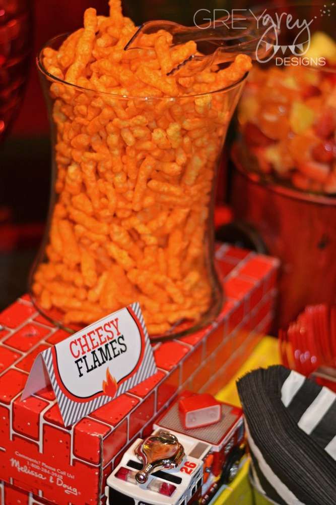 there is a large glass vase filled with cheetos on top of a table