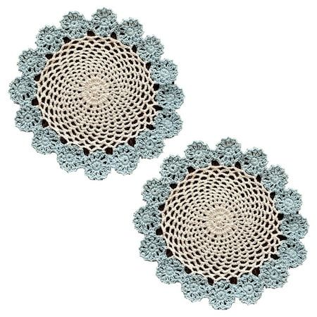 two circular crocheted doilys on a white background, one with black dots