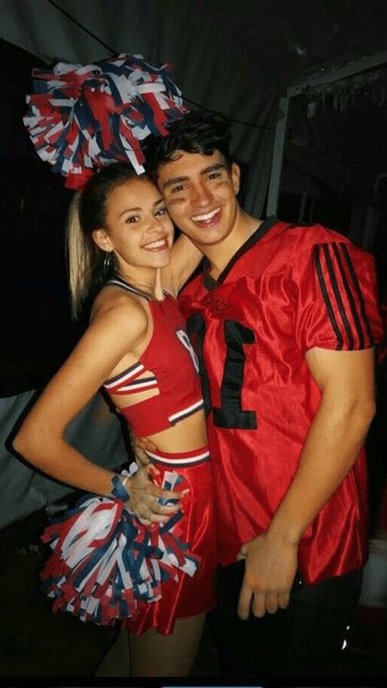 a man and woman dressed up in cheerleader outfits posing for a photo together at an event