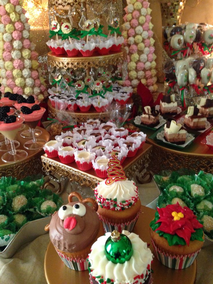 many cupcakes are on display at a holiday party