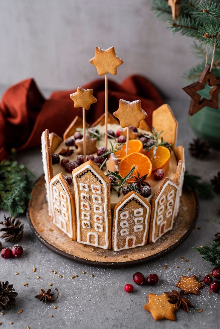 a decorated christmas cake with orange slices and stars on top, surrounded by other decorations