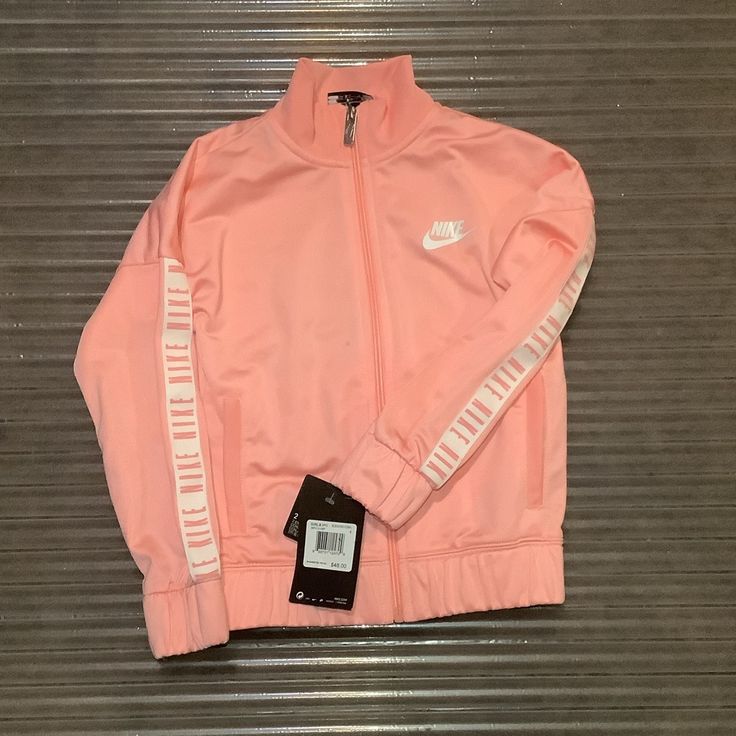 Nike Track Jacket Color: Bleached Coral Which Looks Like A Mix Between Light Pink And Peach Nike Pink Long Sleeve Outerwear, Nike Spring Long Sleeve Track Jacket, Nike Long Sleeve Track Jacket For Spring, Spring Nike Track Jacket With Pockets, Nike Puffer Jacket, Nike Coat, Bleached Coral, Nike Windbreaker Jacket, Nike Track Jacket