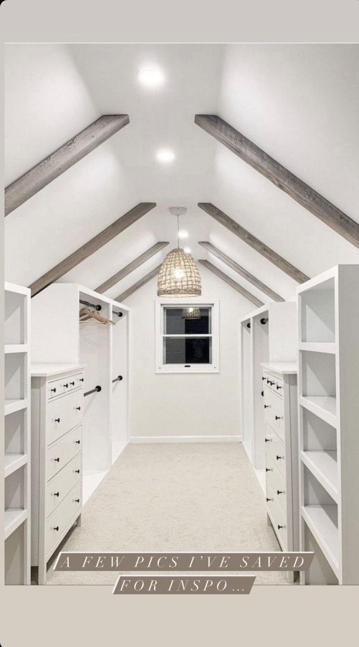 an attic bedroom with white walls and shelving units on the ceiling, along with carpeted flooring