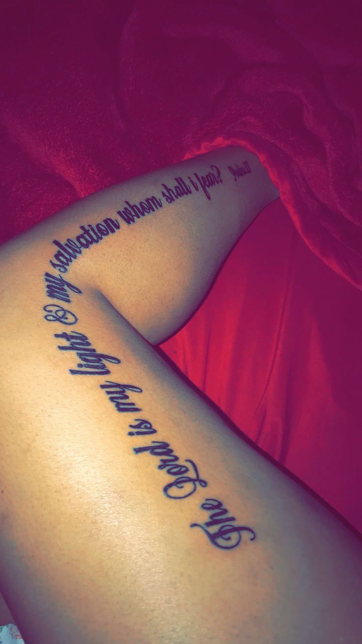 a woman laying on her stomach with a tattoo that reads, you can't stop believing