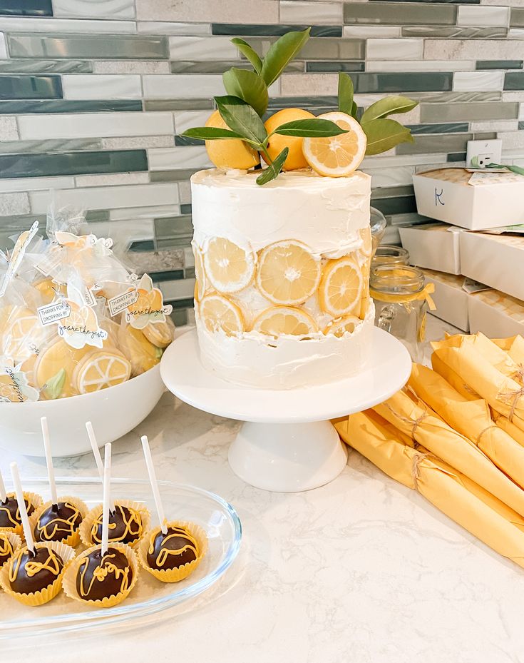 a table with lemons and cakes on it