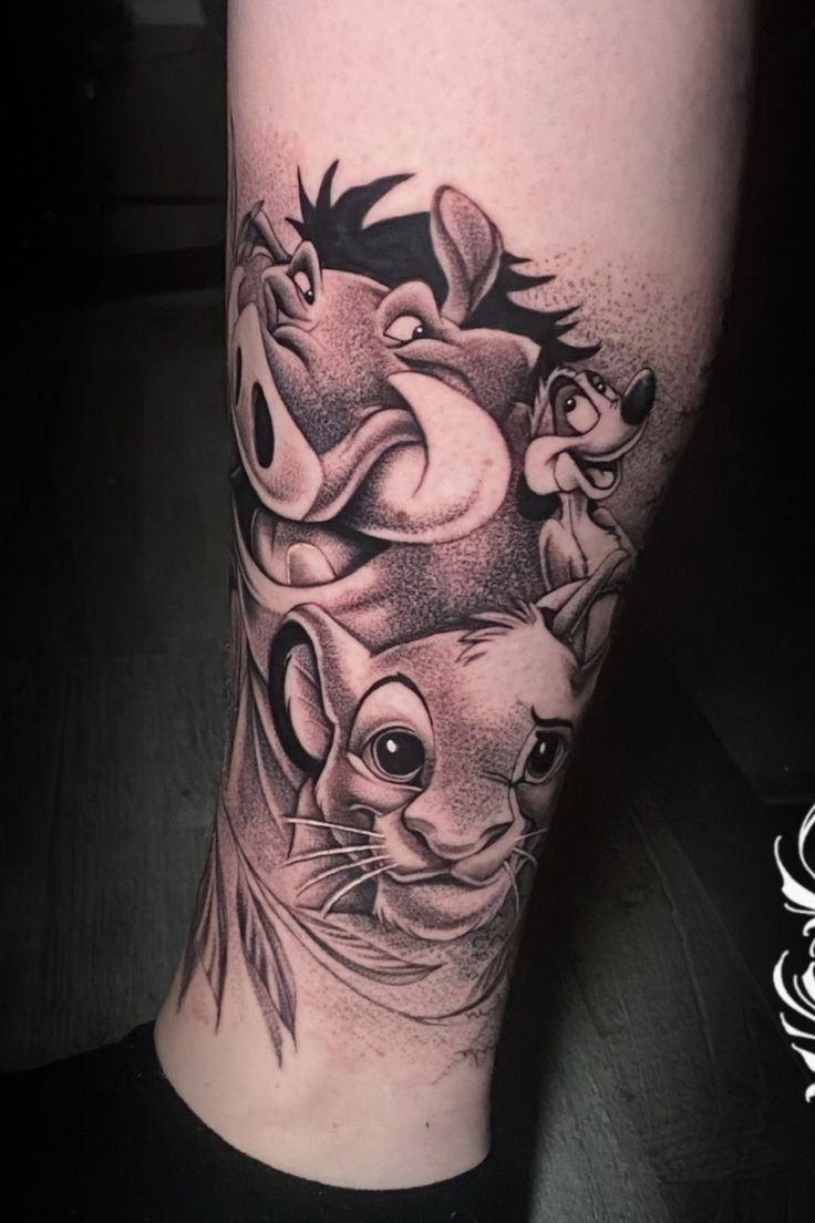 a tattoo on the leg of a person with a lion and other animals around it