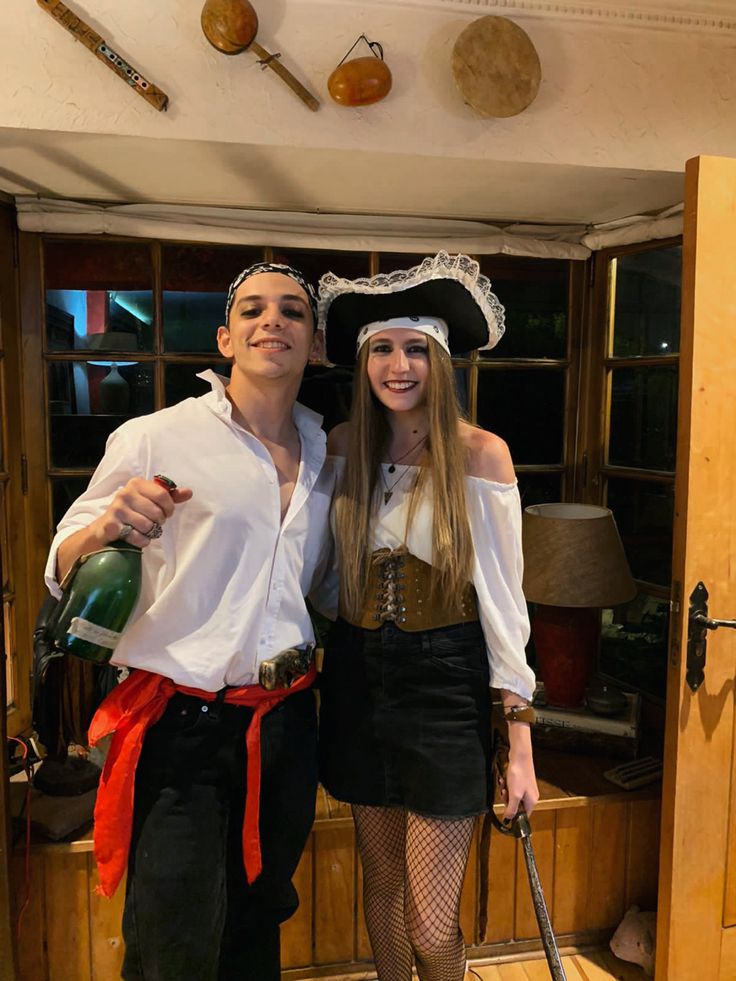 a man and woman dressed up in pirate costumes