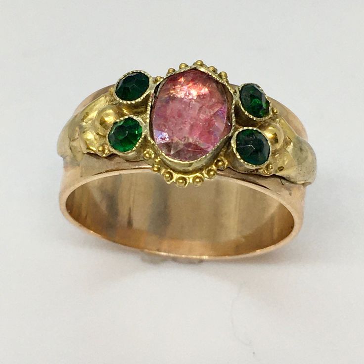 Antique American Marked 14k Gold Edwardian Paste Ring 4.6 Gram Size 6.75 This antique Edwardian paste ring. With a weight of 4.6 grams and a size of 6.75, it features a beautiful oval red paste, which is sure to catch anyone's eye. The ring is made of high-quality yellow gold, and it has been acid-tested to ensure its purity. This ring is perfect for any occasion, whether it's an anniversary, birthday, or Valentine's Day. Its bezel setting style and cocktail style make it a versatile piece of fine jewelry that can be worn with any outfit. The ring is a stunning representation of nature and is a great addition to any vintage and antique jewelry collection. 10 mm wide on top Victorian Oval Yellow Gold Emerald Ring, Victorian Oval Emerald Ring In Yellow Gold, Antique 14k Gold Ruby Ring With Multi-stone, Art Nouveau Gold Ring With Gemstone, Antique Yellow Gold Cabochon Emerald Ring, Antique Yellow Gold Emerald Cabochon Ring, Victorian Style Gold Emerald Ring With Rose Cut Diamonds, Victorian Emerald Ring With Rose Cut Diamonds In Gold, Heirloom Yellow Gold Emerald Cabochon Ring