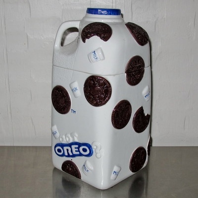 a white jug with chocolate chips on it sitting on top of a metal countertop