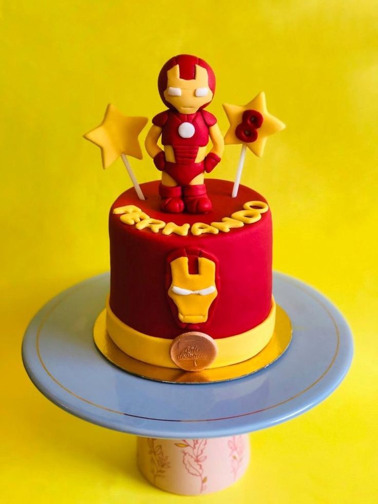 a red and yellow cake with iron man on top