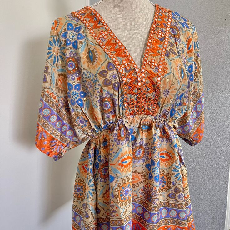 New Naoo National Ak Outfits Boho Bright Orange And Cream Blouse Super Cute Hippy Chic Size S -Scmedium V-Neck Loose Sleeves Eclectic Fun Floral Pattern Fabric: 100% Polyester Made In India Lovely Colors Spring, Summer, Even Fall Orange Bohemian V-neck Top, Orange Printed V-neck Top, Colorful V-neck Top For Vacation, Vibrant Print V-neck Patterned Blouse, Vibrant Print V-neck Blouse, Orange V-neck Top For Festivals, V-neck Blouse With Vibrant Print, Patterned V-neck Beach Blouse, Bohemian Multicolor V-neck Top