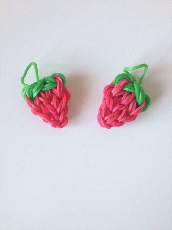 two pieces of fruit shaped like hearts on a white surface with green and pink yarn