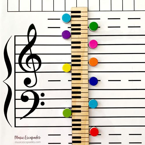 a ruler with musical notes on it and colorful buttons attached to the side of it