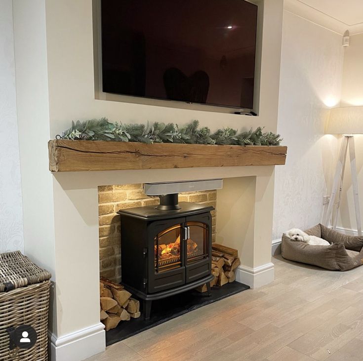 a living room with a fireplace and television mounted on the wall