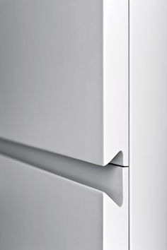 a close up view of the door handle on a refrigerator freezer that is white