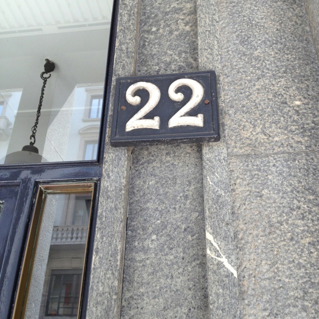 the number twenty two is mounted to the side of a building