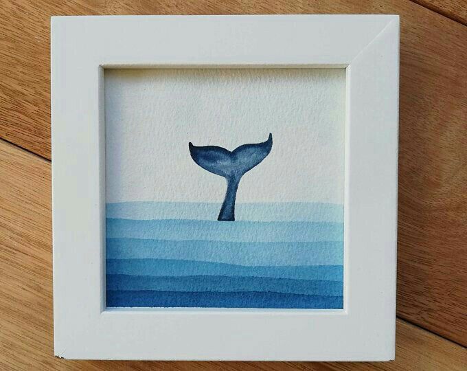 a watercolor painting of a whale's tail in blue and white on wood