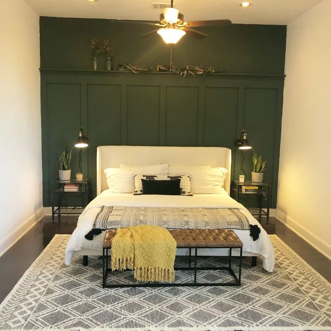 a bedroom with green walls and white bedding