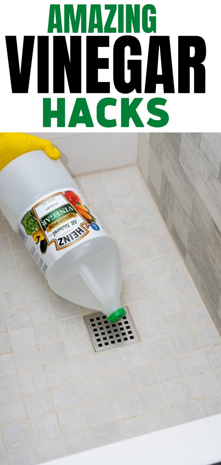 a bottle of vinegar cleaning tricks and tips on a tile floor with the words vinegar cleaning tricks and tips