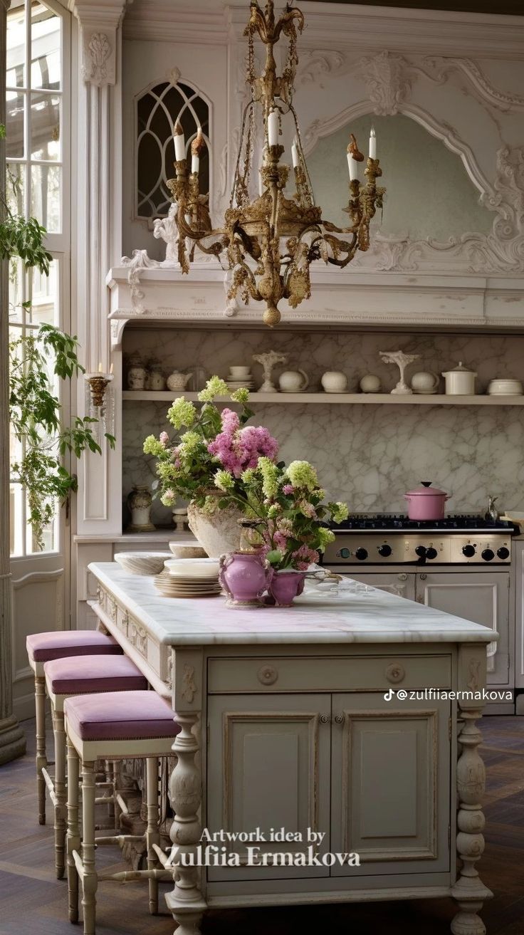 a chandelier hangs from the ceiling above a kitchen island with flowers on it