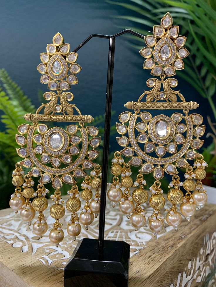 Premium quality High gold plated, pearl work, hand carved work , AD lining and kundan work. Clip back.  about 5 inch long  Absolute designer piece and statement earring. Kundan Chandbali, Kundan Work, Pearl Work, Chandbali Earrings, Kundan Earrings, Earring Gold, Statement Earring, Head Accessories, Stunning Earrings