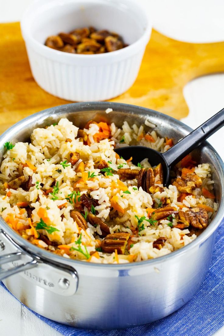 a pot filled with rice and nuts on top of a blue towel