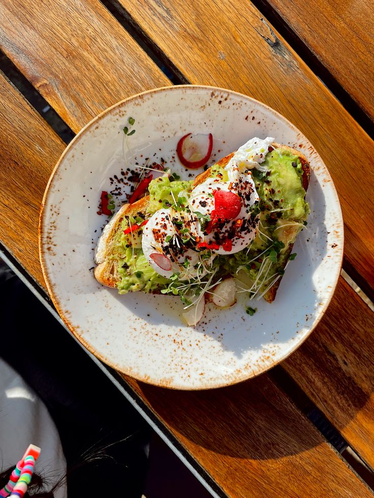 a white plate topped with a sandwich on top of a wooden table