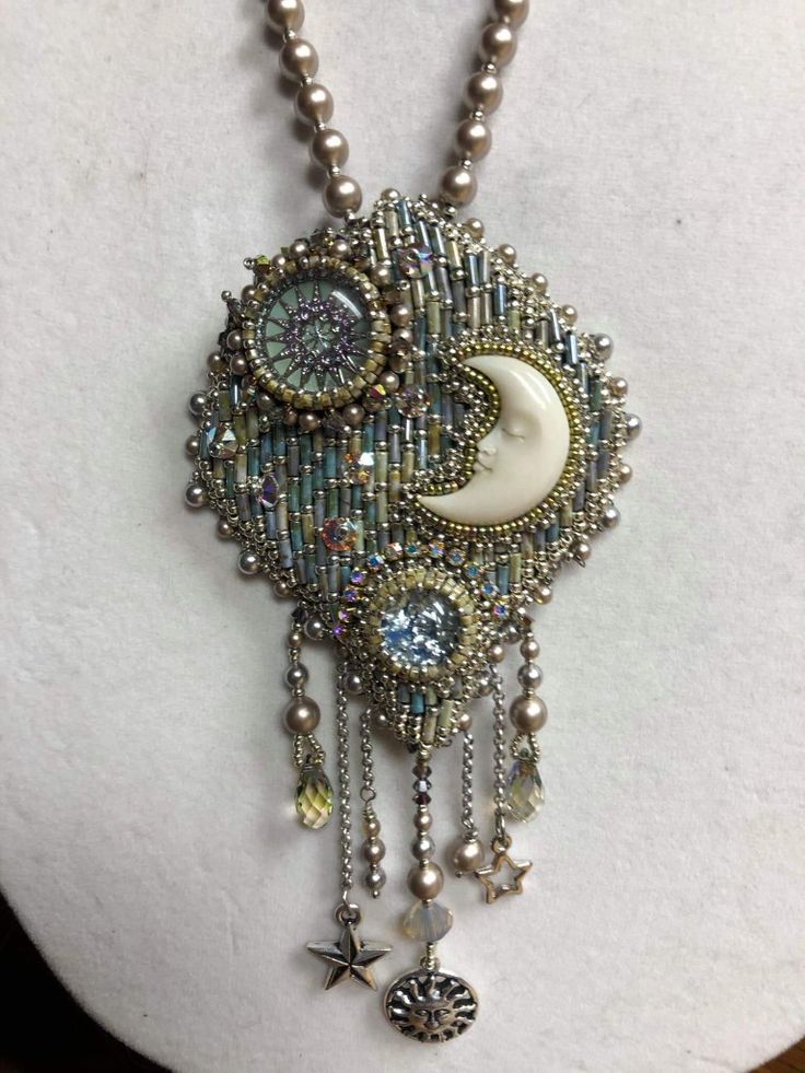 a necklace with beads and charms hanging from it