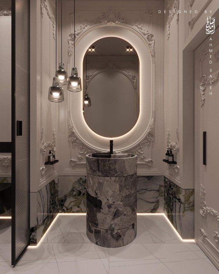 an elegant bathroom with marble counter tops and lights on the walls, along with round mirrors