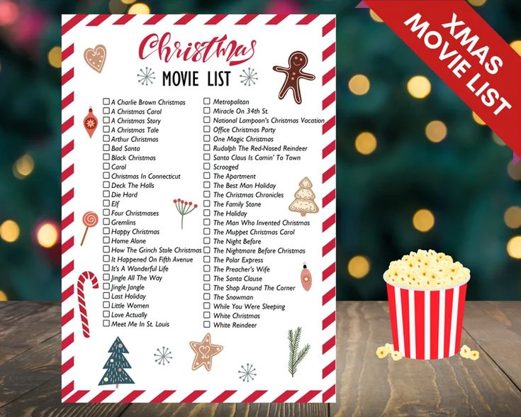 a christmas movie list is shown next to a cup of popcorn and a candy cane