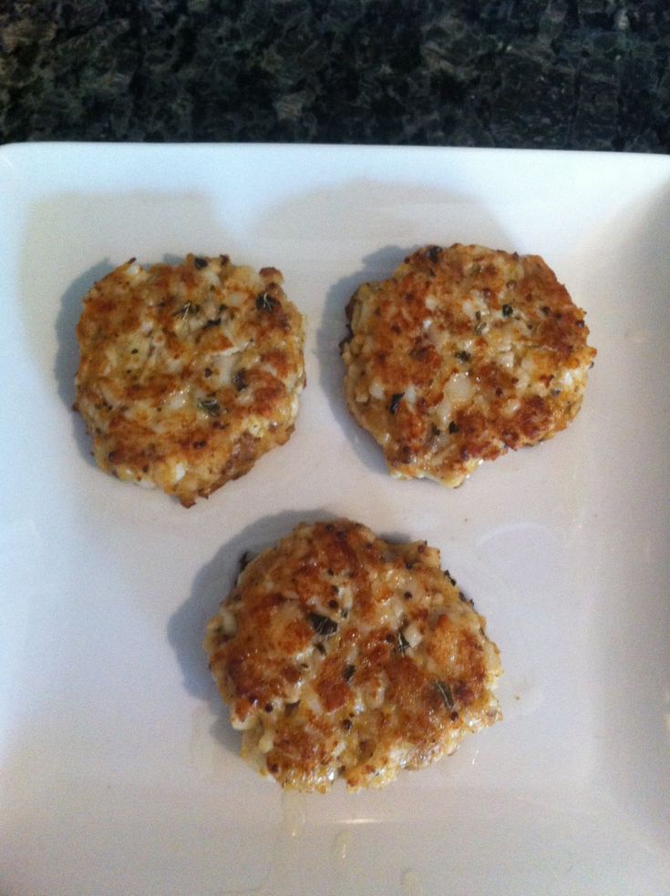 three crab cakes on a white plate