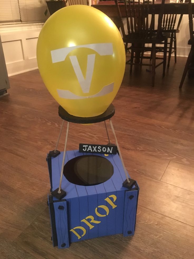 an inflatable balloon sitting on top of a blue box with the word drop written on it